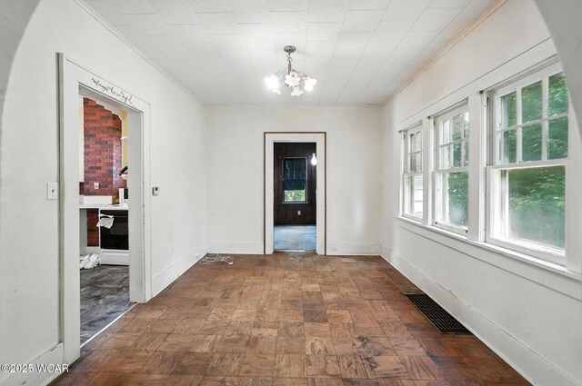 513 Gordon Ave, Van Wert, OH 45891 - unfurnished dining area featuring ornamental molding, a chandelier, and plenty of natural light
