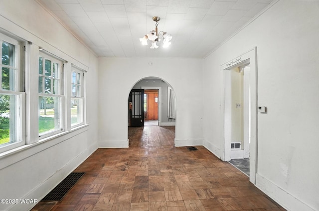 513 Gordon Ave, Van Wert, OH 45891 - hallway with arched walkways, a chandelier, and crown molding