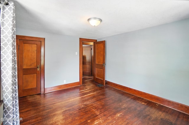 1574 Oakland Pkwy, Lima, OH 45805 - unfurnished bedroom featuring dark wood-style floors