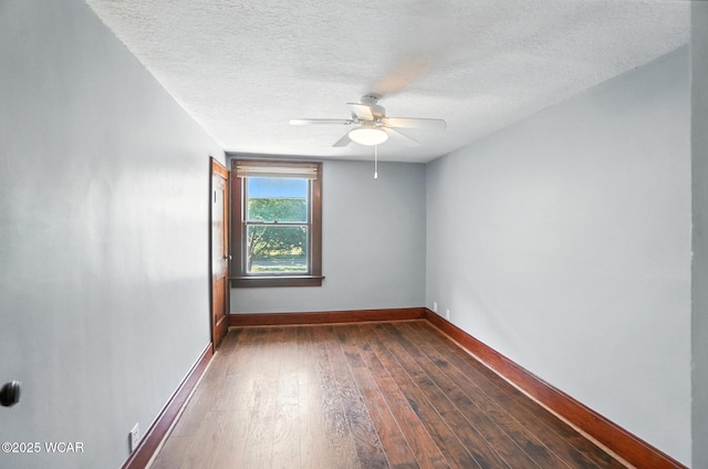 1574 Oakland Pkwy, Lima, OH 45805 - spare room with ceiling fan, dark wood-style floors, and a textured ceiling