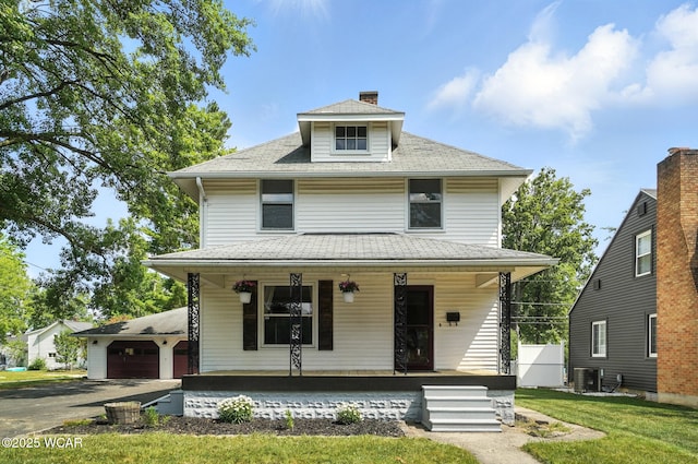1574 Oakland Pkwy, Lima, OH 45805 - american foursquare style home with covered porch, a front yard, and a chimney