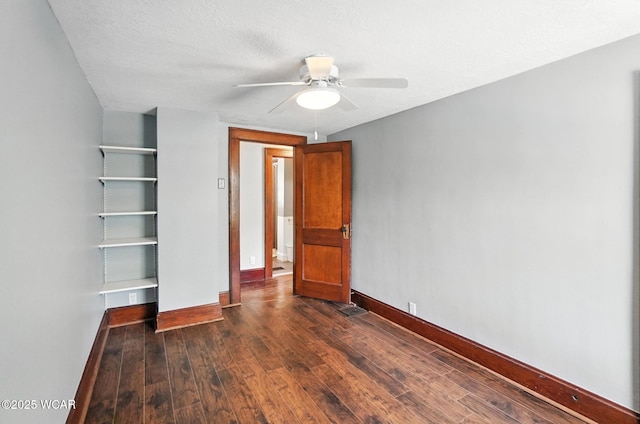 1574 Oakland Pkwy, Lima, OH 45805 - unfurnished bedroom featuring dark wood-type flooring, a ceiling fan, and a closet