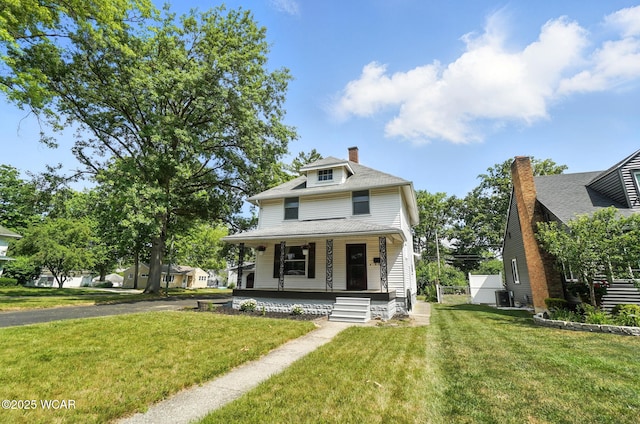1574 Oakland Pkwy, Lima, OH 45805 - american foursquare style home with covered porch, a front lawn, and a chimney