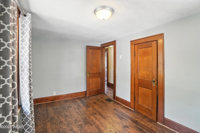 1574 Oakland Pkwy, Lima, OH 45805 - unfurnished bedroom featuring baseboards and dark wood finished floors