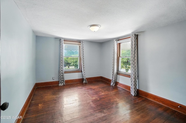 1574 Oakland Pkwy, Lima, OH 45805 - spare room featuring wood-type flooring and a textured ceiling