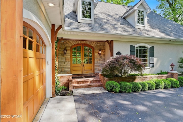 7 Estate Dr, Lima, OH 45805 - property entrance with roof with shingles, stone siding, french doors, stucco siding, and a porch