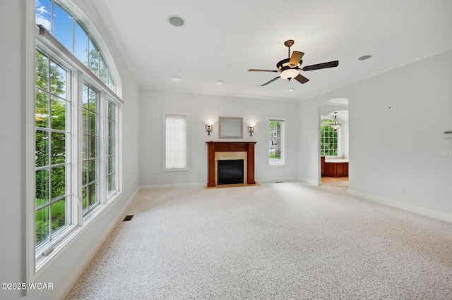 7 Estate Dr, Lima, OH 45805 - unfurnished living room featuring baseboards, a fireplace with flush hearth, ceiling fan, and arched walkways
