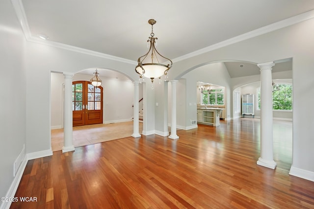 7 Estate Dr, Lima, OH 45805 - spare room with healthy amount of natural light, arched walkways, wood finished floors, and ornamental molding
