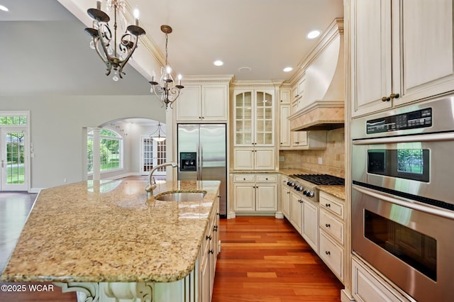 7 Estate Dr, Lima, OH 45805 - kitchen with stainless steel appliances, a sink, arched walkways, cream cabinetry, and recessed lighting