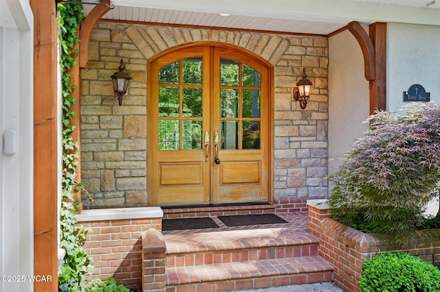 7 Estate Dr, Lima, OH 45805 - property entrance featuring french doors, stone siding, and stucco siding
