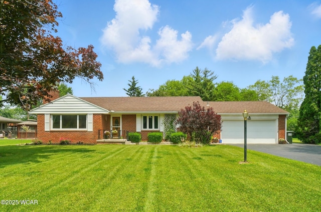 2050 Rosewood Ln, Lima, OH 45806 - ranch-style house featuring a garage, driveway, brick siding, and a front lawn
