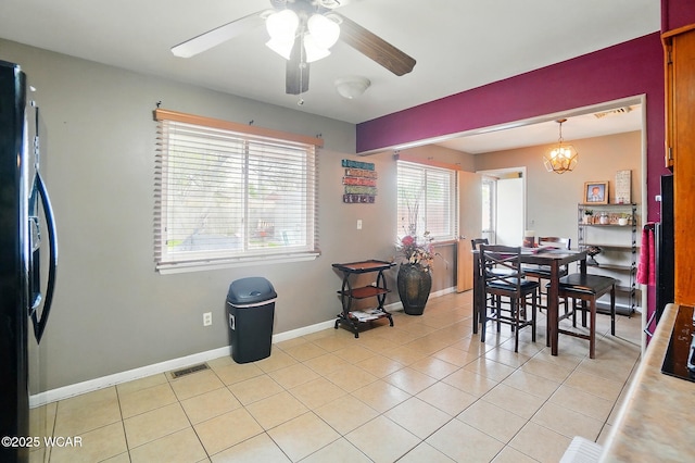 642 Meadowbrook Dr, Lima, OH 45801 - dining space with a ceiling fan, light tile patterned flooring, baseboards, and a chandelier