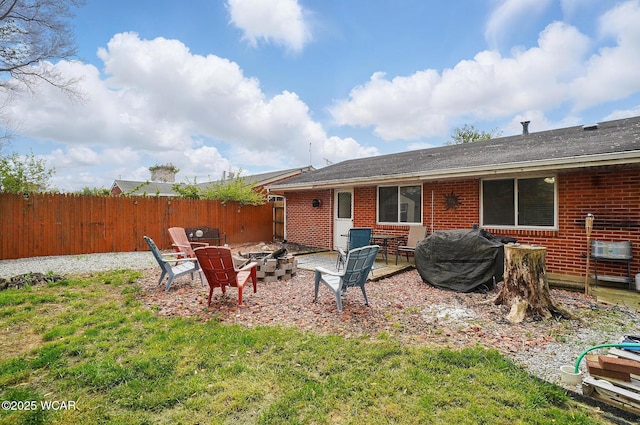 642 Meadowbrook Dr, Lima, OH 45801 - rear view of property featuring an outdoor fire pit and brick siding