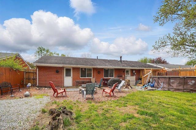 642 Meadowbrook Dr, Lima, OH 45801 - rear view of property with an outdoor fire pit, brick siding, and an outdoor pool