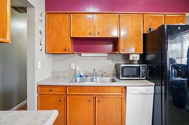 642 Meadowbrook Dr, Lima, OH 45801 - kitchen with a sink, dishwasher, stainless steel microwave, black fridge, and light countertops