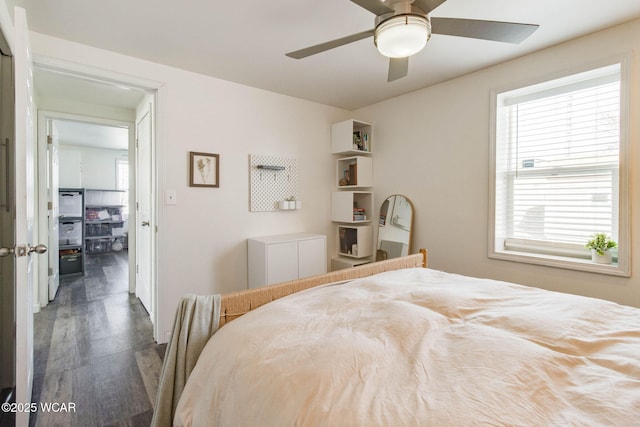 bedroom with dark hardwood / wood-style floors and ceiling fan