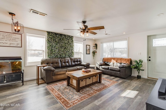 living room featuring dark hardwood / wood-style flooring, a wealth of natural light, and ceiling fan