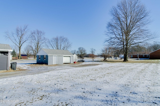 yard covered in snow with a garage