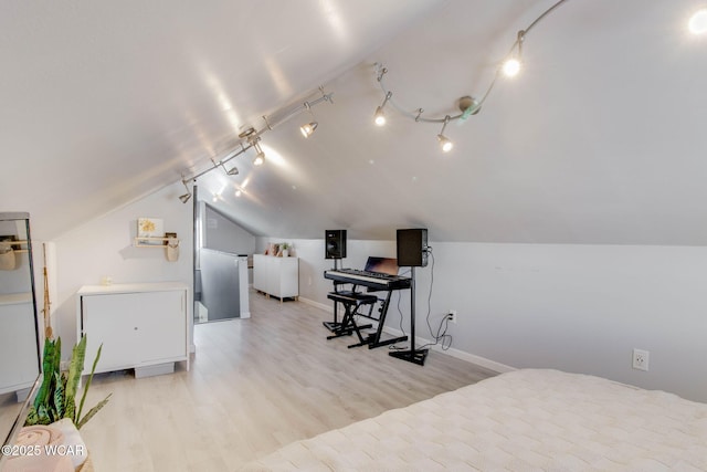 bedroom with lofted ceiling and light hardwood / wood-style floors