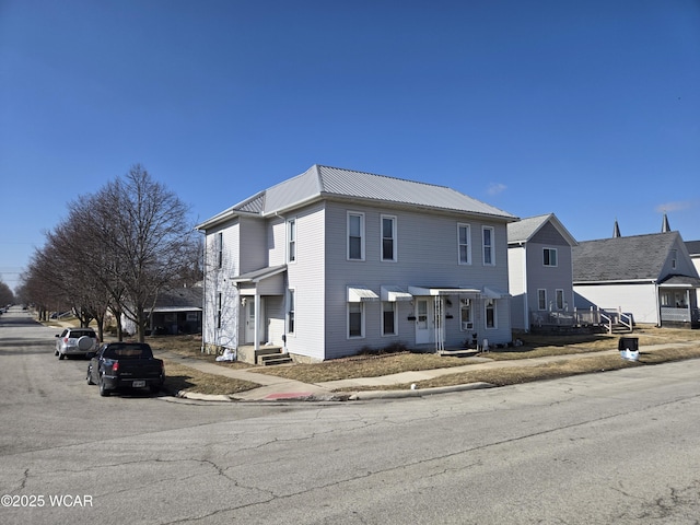 view of front of home featuring a residential view and metal roof