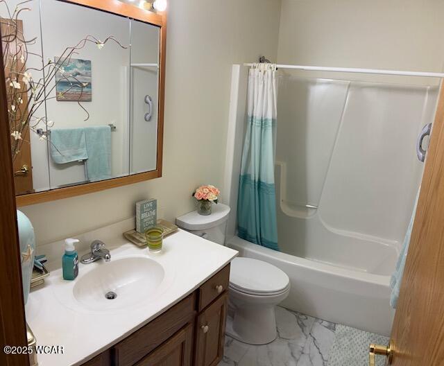 bathroom with toilet, marble finish floor, shower / tub combo with curtain, and vanity