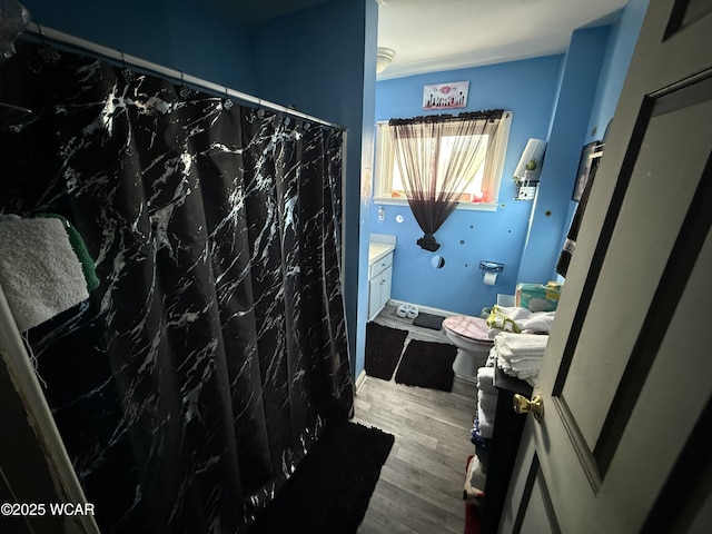 bathroom featuring vanity, toilet, curtained shower, and hardwood / wood-style floors