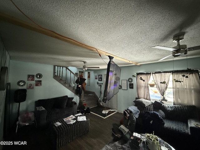 living room featuring ceiling fan, dark hardwood / wood-style floors, and a textured ceiling