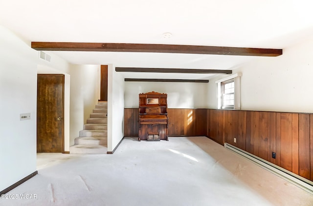 carpeted living room featuring a baseboard heating unit, wooden walls, and beam ceiling