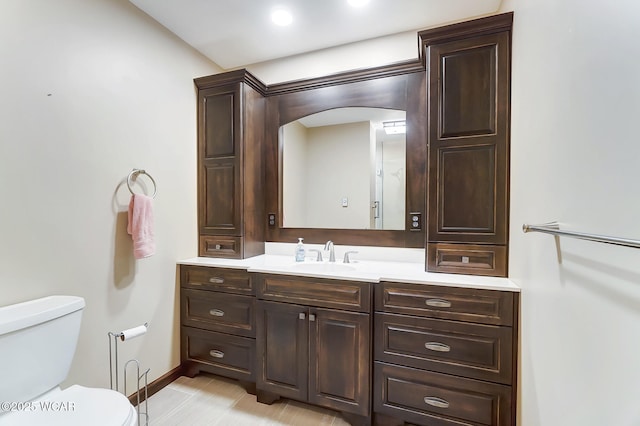 bathroom featuring vanity and toilet