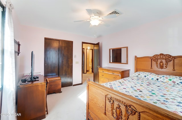 carpeted bedroom with a closet and ceiling fan