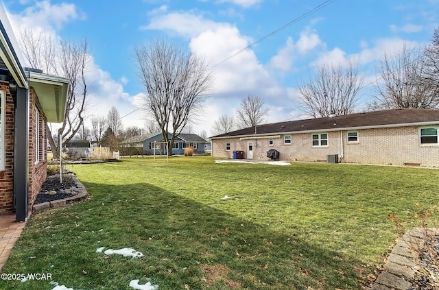 view of yard featuring a patio and central AC