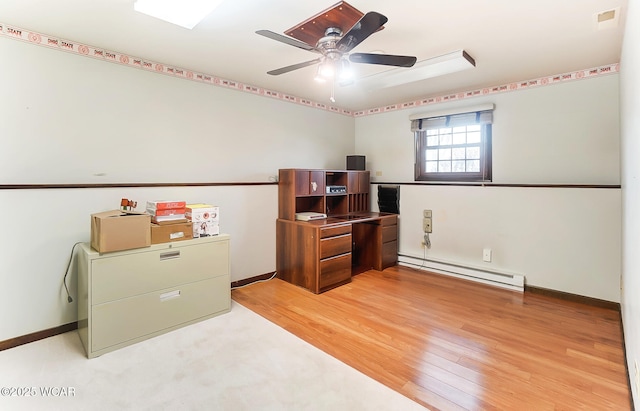 office area with ceiling fan, a baseboard heating unit, and light hardwood / wood-style floors