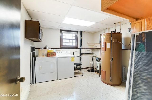 laundry area with water heater, cabinets, and independent washer and dryer