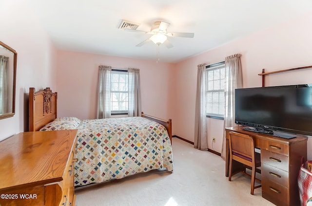 carpeted bedroom with multiple windows and ceiling fan