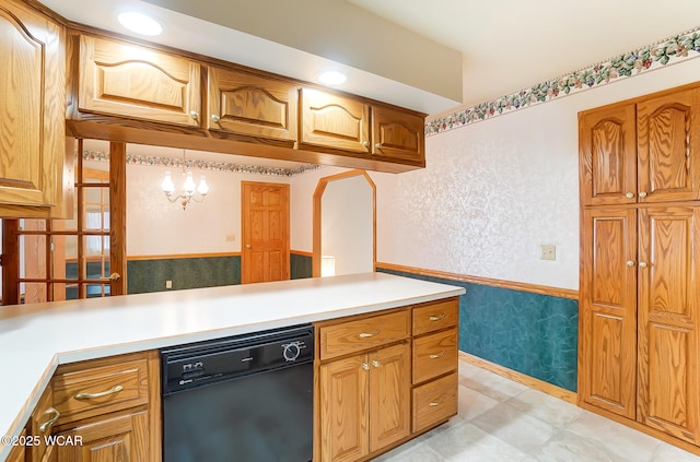 kitchen featuring decorative light fixtures and black dishwasher