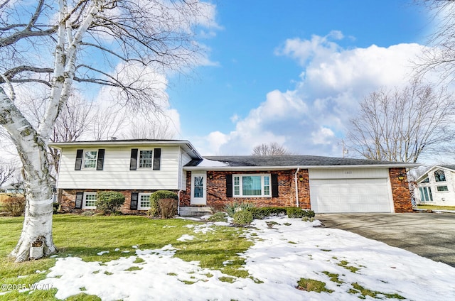 split level home with a garage and a lawn