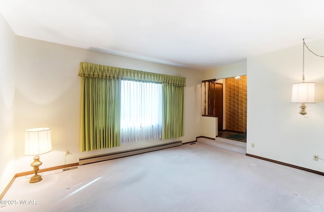 carpeted spare room featuring a baseboard radiator