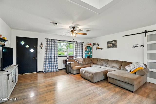 718 Wildwood Ave, Lima, OH 45807 - living area with a barn door, ceiling fan, wood finished floors, and baseboards