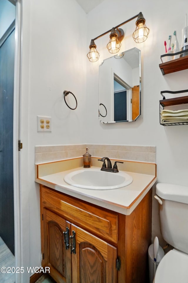 718 Wildwood Ave, Lima, OH 45807 - half bathroom featuring vanity and toilet