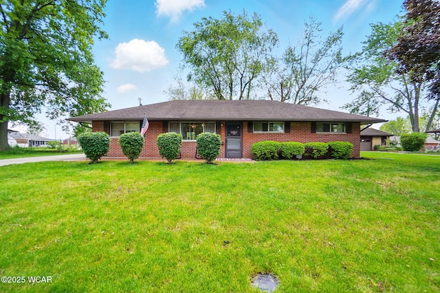 718 Wildwood Ave, Lima, OH 45807 - single story home with brick siding, a front yard, and driveway