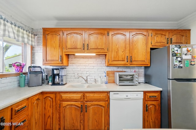 718 Wildwood Ave, Lima, OH 45807 - kitchen with dishwasher, freestanding refrigerator, a sink, ornamental molding, and light countertops