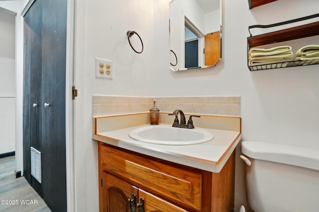 718 Wildwood Ave, Lima, OH 45807 - bathroom with vanity, toilet, and wood finished floors