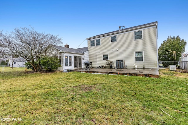 back of house with a lawn and central air condition unit