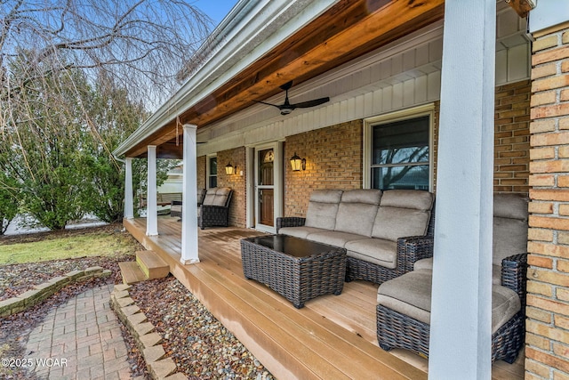 wooden terrace with ceiling fan and an outdoor hangout area