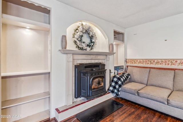 living room featuring dark hardwood / wood-style floors and a wood stove