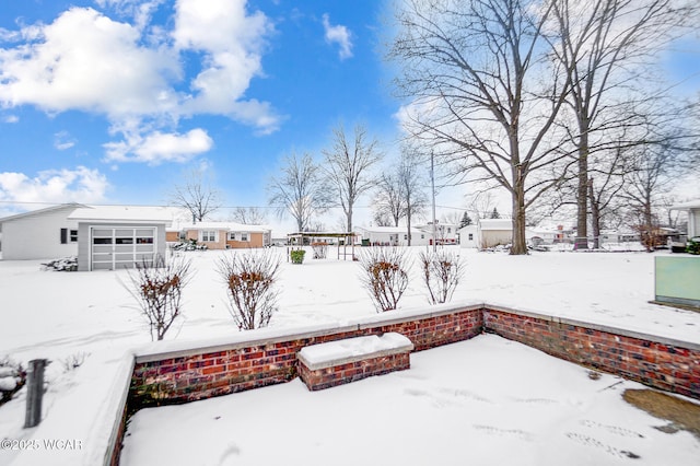 yard covered in snow with a garage