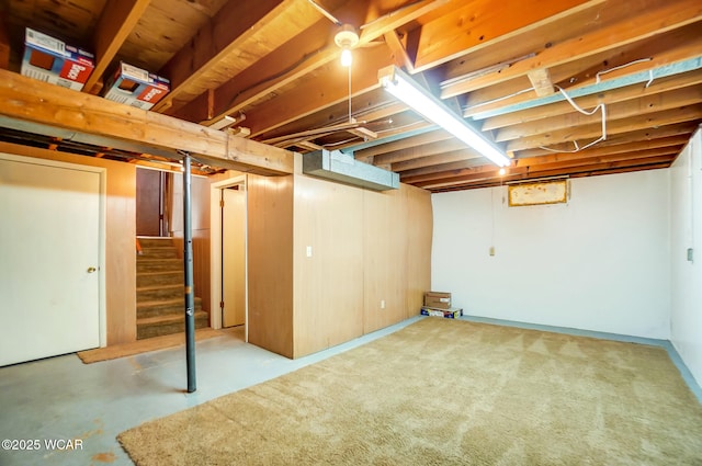 unfinished basement featuring stairway