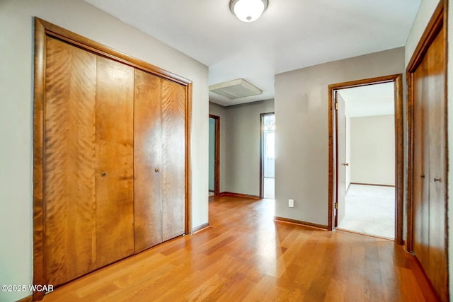 hall with light wood finished floors and baseboards