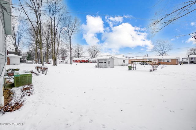 yard layered in snow featuring central AC unit