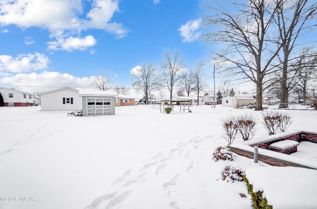 yard covered in snow with a garage